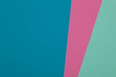 Mavi, yeşil ve pembe arkaplan, renkli kağıt geometrik olarak bölgelere bölünür, çerçeve, boşluk kopyala.