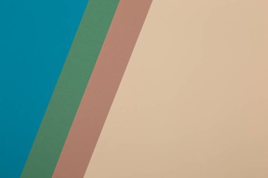 Mavi, yeşil, kahverengi ve sarı arkaplan, renkli kağıt geometrik olarak bölgelere bölünür, çerçeve, boşluk kopyala.