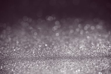 Dark purple glitter surface with white light bokeh - Halloween themed color clipart