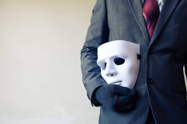 Business man carrying white mask to his body indicating Business fraud and faking business partnership clipart