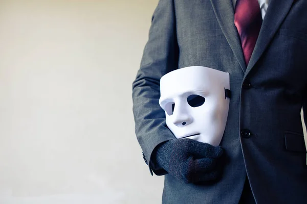 Business man carrying white mask to his body indicating Business fraud and faking business partnership — Stock Photo, Image