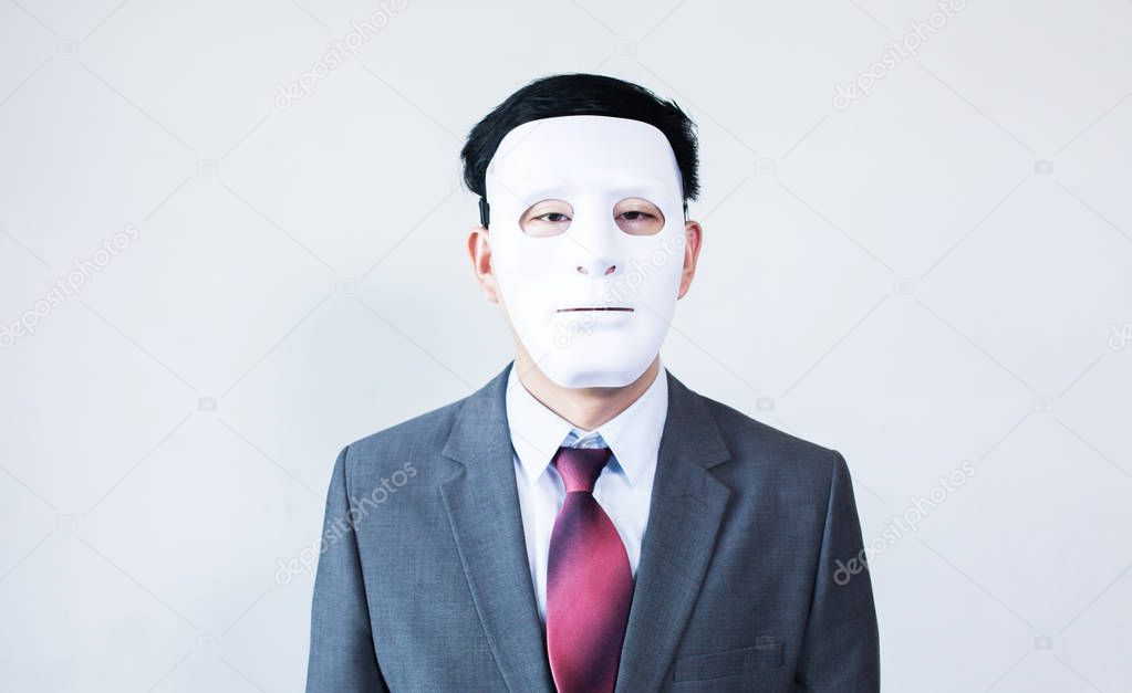 Businessman in disguise mask in white background