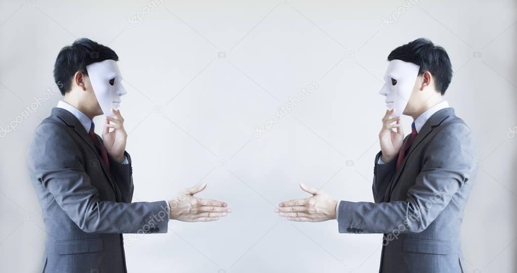 Two men in business suit handshaking with masks on - Business fraud and hypocrite agreement.