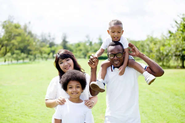 Happy diverse and mixed race family group photo in the park — Stock Photo, Image