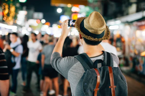 Young Asian traveler taking photo with mobile phone in Khaosan road in Bangkok, Thailand — Stock Photo, Image