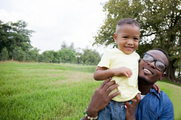 Mutlu Afro-Amerikan baba ve oğul yeşil parkta oynarken — Stok fotoğraf