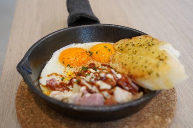 Asian fried egg pan cuisine in Thai traditional style servied on table