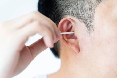 Man cleaning ears with cotton swabs