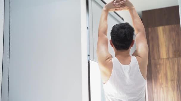 Joven haciendo ejercicios matutinos en casa — Vídeos de Stock