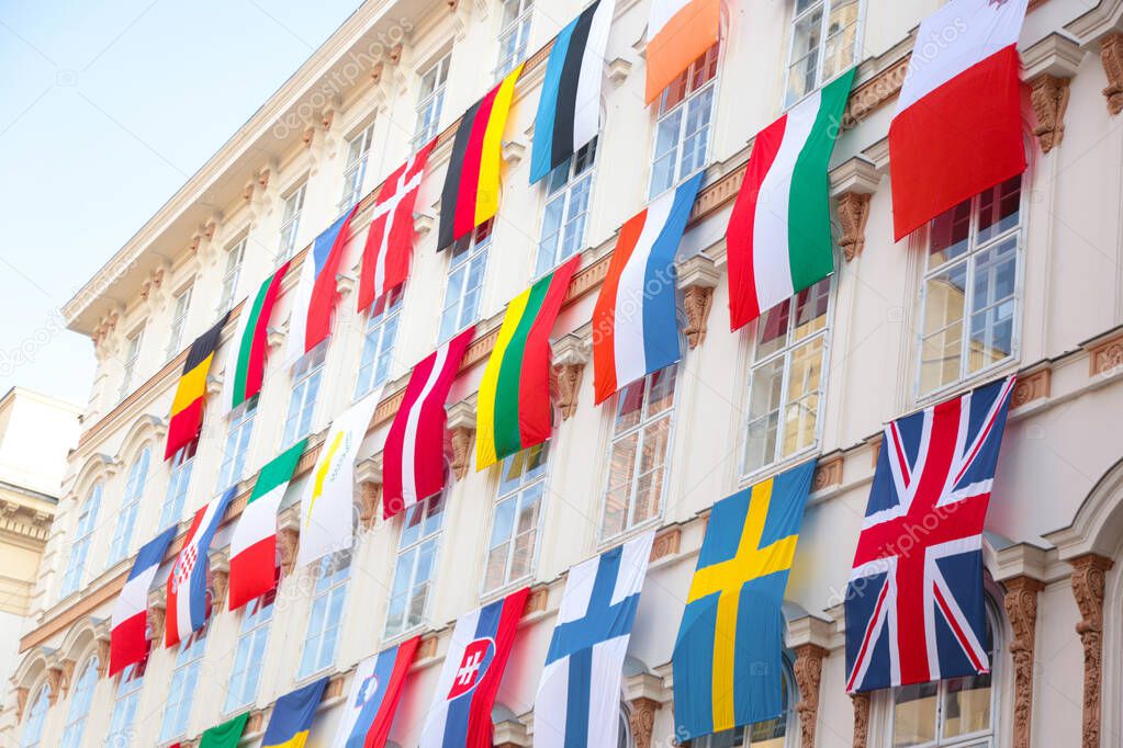 Set of European flags hanging on building with EU and UN flags in Vienna, Austria