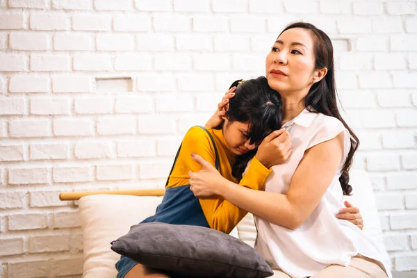 Asian mother comforting crying teenage daughter in miserable, stressed, depressed, sad state of mind — Stock Photo, Image