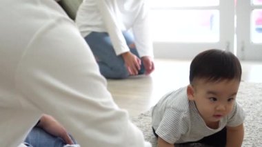Baby boy crawling to parents