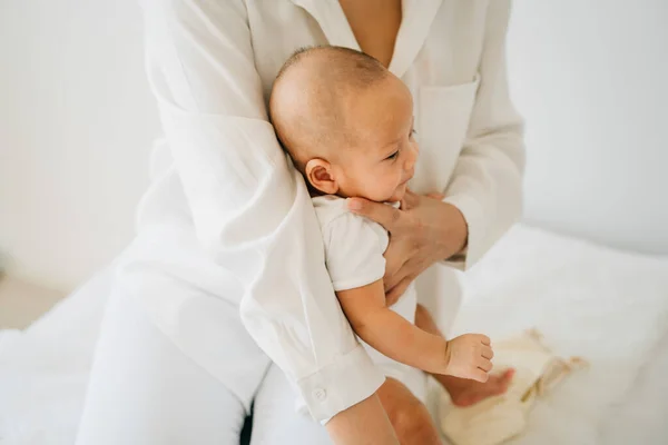 Mom with Asian baby on legs — 스톡 사진