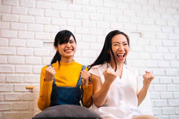 Excited Asian females watching TV — Stock Photo, Image