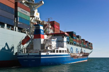 Nakhodka, Primorsky bölge / Rusya - 06 Temmuz 2016: tanker Zaliv'e Nakhodka bir büyük konteyner gemisi Cosco Pekin Bunkering.