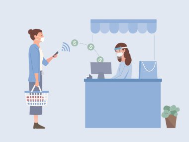 Cerrahi maske takan ve alışveriş sepetini tutan kadınlar, alışveriş merkezinin kasiyerindeki kasaya para göndermek için mobil ödemeleri internet üzerinden yapıyorlar. Yeni normal..