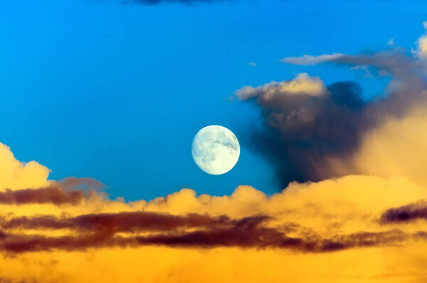 Cumulus thunder clouds evening sunset sky moon