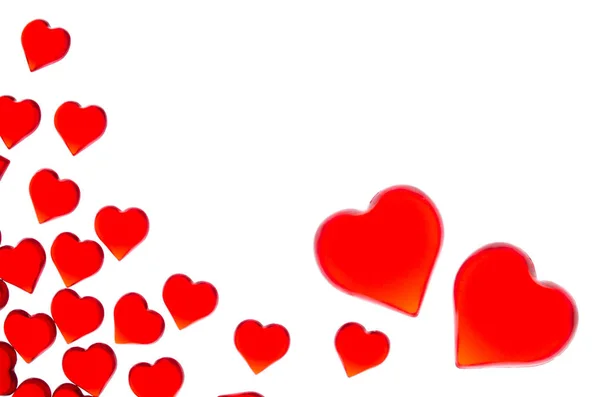Corazones rojos brillantes en dos grandes corazones en la esquina derecha. Para utilizar el Día de San Valentín, bodas, Día Internacional de la Mujer — Foto de Stock