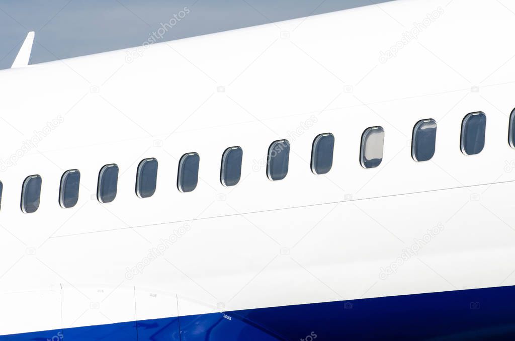 Many porthole on the big white plane