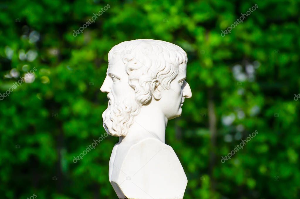 Sculpture head on both sides conceptually profile of a human face in the park