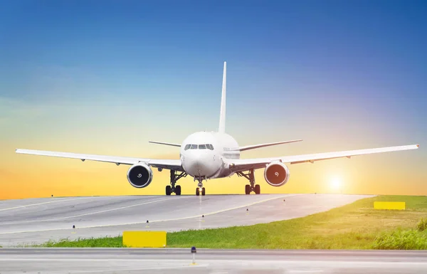Grande aeronave em taxiing por do sol no aeroporto, o céu é o sol ea pista de direção — Fotografia de Stock