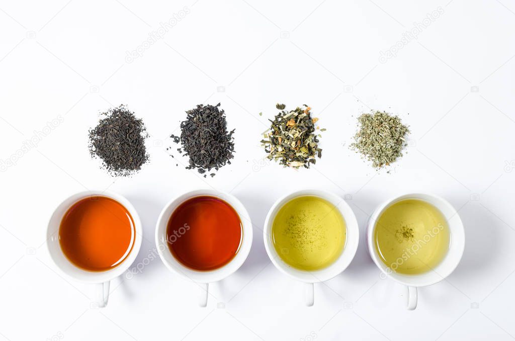 Collection of different teas in cups with tea leaves on a white background