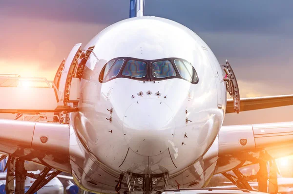 Airplane view from the front cockpit fuselage at sunset at the airport — Stock Photo, Image