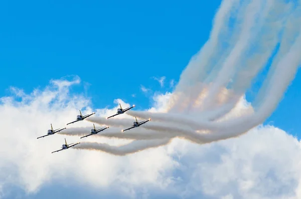 Αεροπλάνα μαχητικά αεροσκάφη καπνίζουν το φόντο του μπλε ουρανού άσπρα σύννεφα. Ρωσία, Μόσχα. Αύγουστος 2015. — Φωτογραφία Αρχείου
