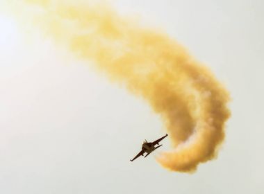 Güneşin ve bulutların arka planı bir savaşçı bir rakam akrobasi yapılır.