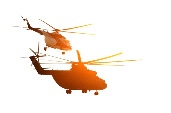 Two helicopters fly beside the sun. — Stock Photo, Image