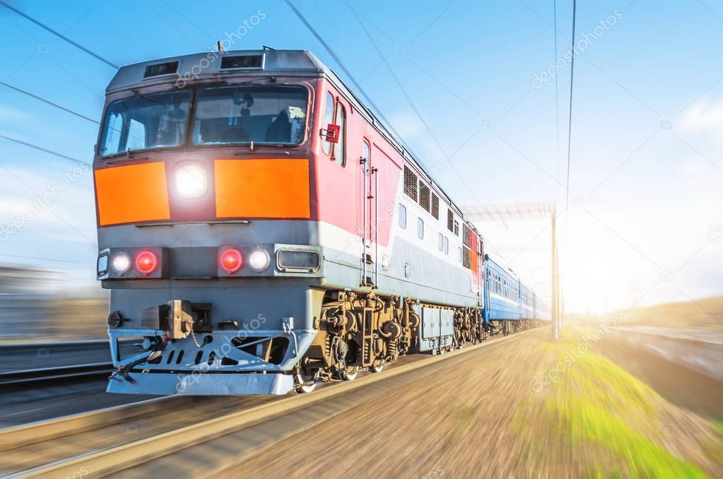 Passenger diesel train traveling speed railway wagons journey sunset light.