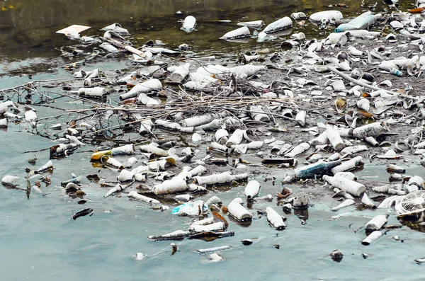 Plenty of plastic and glass bottles on the bottom of the river pollution.