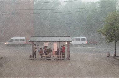 Crowd of people are hiding from heavy rain at a stop in the city clipart
