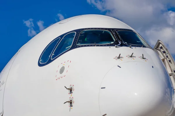 Носовая кабина пассажирского самолета в голубом небе облаков — стоковое фото