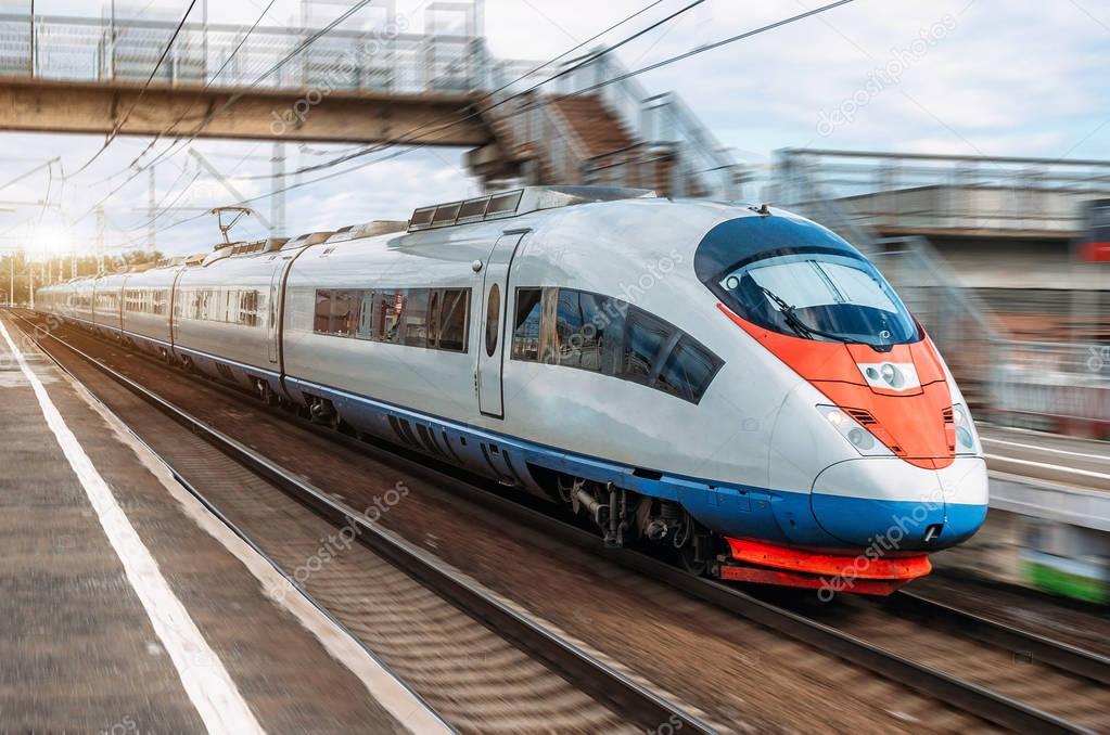 The electric train drives at high speed at the station