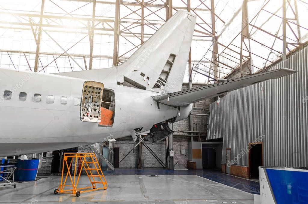 Aircraft in the hangar in the maintenance of plating, interior, tail repair