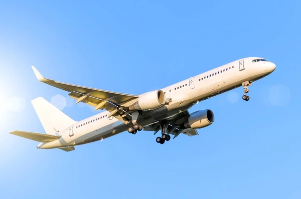 Avión blanco de pasajeros aterrizando en el aeropuerto en el cielo azul —  Fotos de Stock