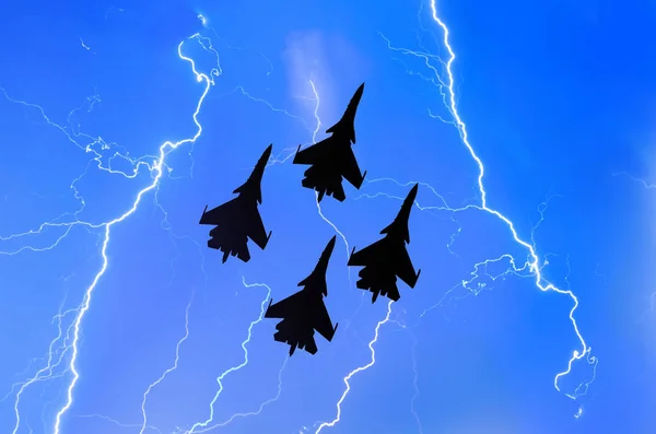 Group of combat fighters jet against the background of lightning thunderstorms weather at night — Stock Photo, Image