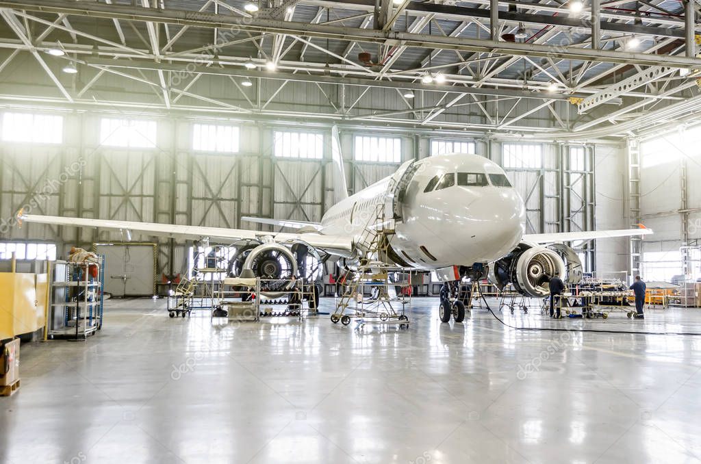 Passenger aircraft on maintenance of engine and fuselage repair in airport hangar