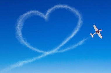 Love figurative heart from a white smoke trail airplane clipart