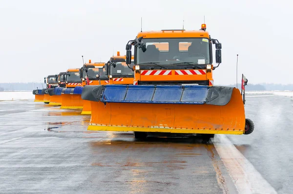 Snowplows no trabalho na pista no aeroporto — Fotografia de Stock