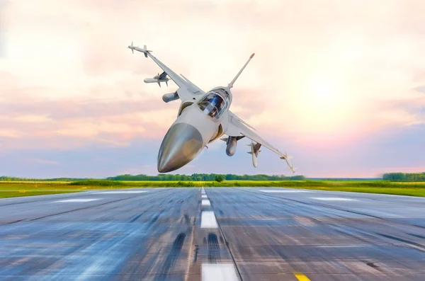 Avión de combate militar vuela a alta velocidad sobre la pista de rodaje en el aeropuerto . — Foto de Stock