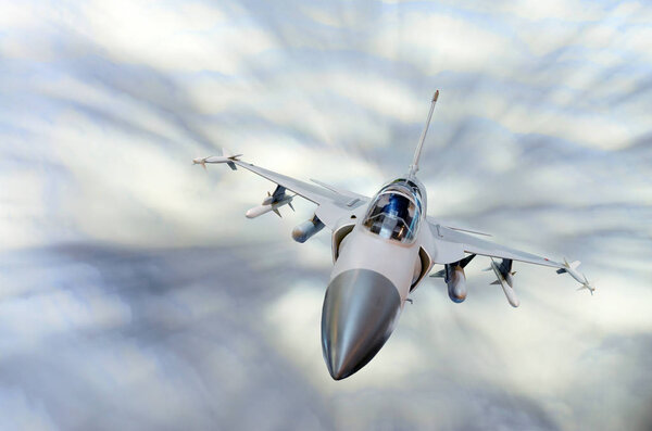 Military fighter aircraft at high speed, flying high in the sky.