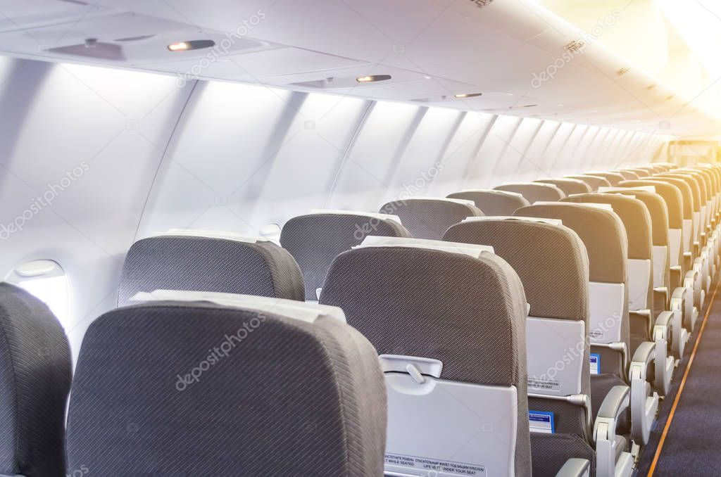 Rows of passenger seats in the cabin airplane.