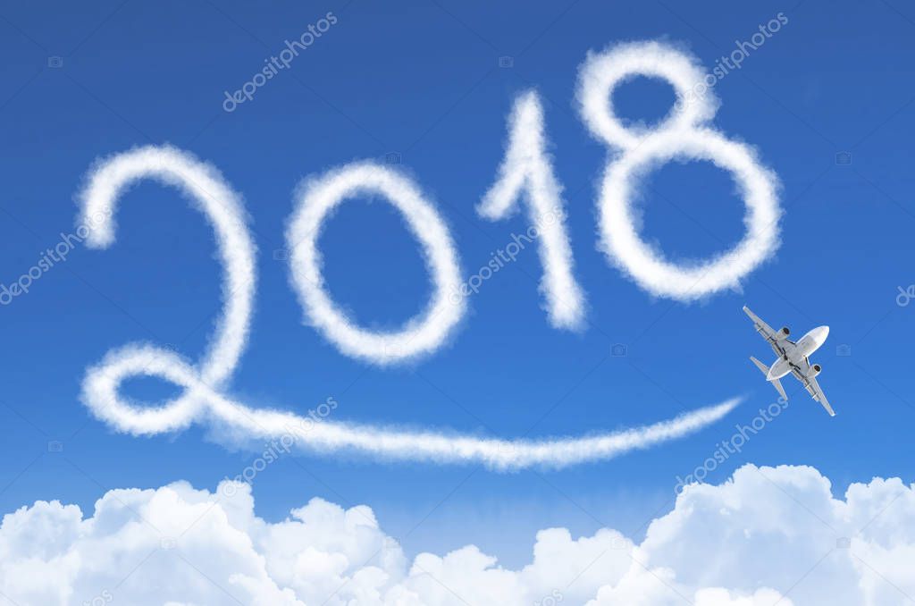 Happy New year 2018 concept. Drawing by airplane vapor contrail in sky.