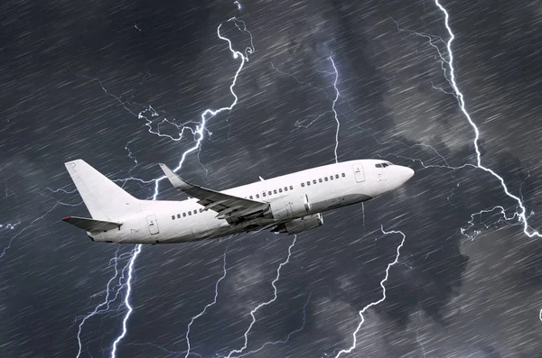 White passenger airplane takes off during a thunderstorm night lightning strike of rain, bad weather.