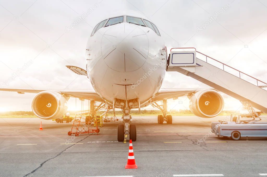 Passenger aircraft parked at the airport with ladder ladder.