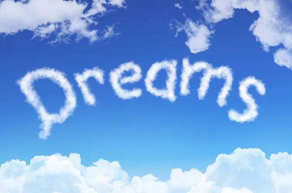 Word dromen uit de wolken tegen de blauwe hemel. — Stockfoto