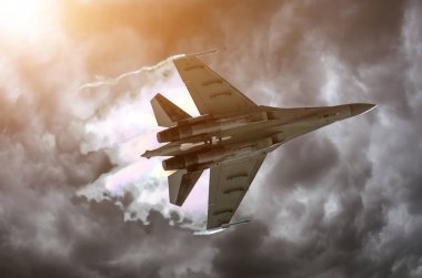 Battle fighter jet flying dives breaking clouds on a thunderstorm sky. clipart