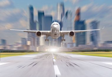 Havaalanında uçak şehir ve gökdelenler arka plan karşı çıkar.
